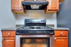 586 Windchase Ln, Stone Mountain, GA 30083 - kitchen featuring stainless steel appliances, brown cabinets, and exhaust hood