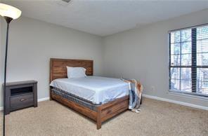 586 Windchase Ln, Stone Mountain, GA 30083 - bedroom with baseboards and carpet flooring