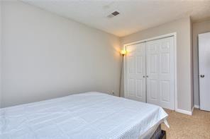 586 Windchase Ln, Stone Mountain, GA 30083 - carpeted bedroom with a closet, baseboards, and visible vents