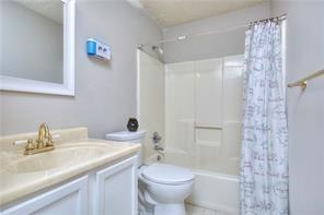 586 Windchase Ln, Stone Mountain, GA 30083 - full bathroom with toilet, shower / tub combo with curtain, and vanity