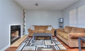 586 Windchase Ln, Stone Mountain, GA 30083 - living area with baseboards, wood finished floors, and a fireplace