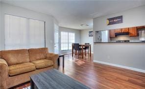 586 Windchase Ln, Stone Mountain, GA 30083 - living room featuring baseboards and wood finished floors