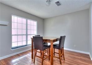 586 Windchase Ln, Stone Mountain, GA 30083 - dining area with a wealth of natural light, visible vents, baseboards, and wood finished floors