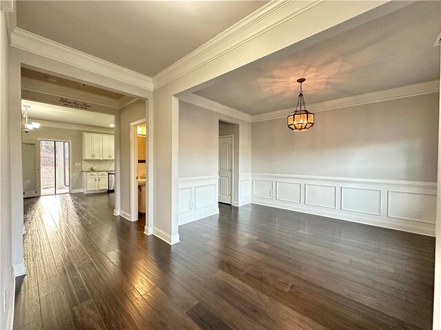 kitchen featuring a center island, white cabinetry, stainless steel appliances, sink, and hanging light fixtures