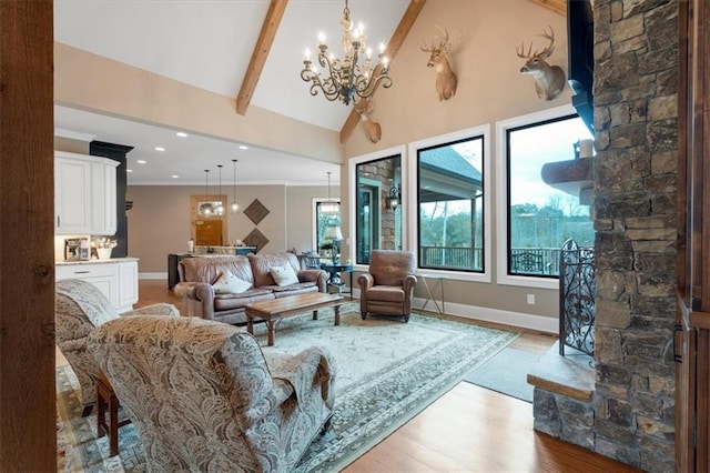 living room with an inviting chandelier, high vaulted ceiling, beamed ceiling, crown molding, and light wood-type flooring