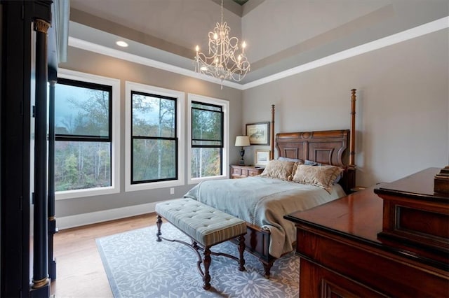 bedroom featuring ornamental molding, light hardwood / wood-style floors, and a notable chandelier