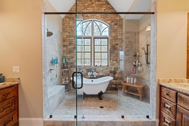 bathroom with independent shower and bath, vanity, and vaulted ceiling