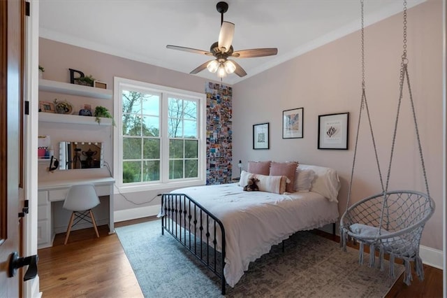 bedroom with hardwood / wood-style flooring, ceiling fan, and crown molding