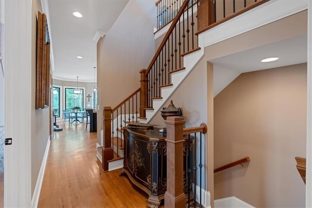 stairs with a chandelier and wood-type flooring