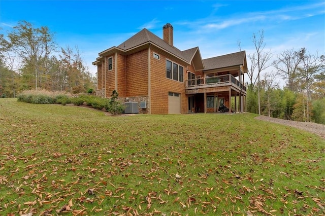 back of house with central AC unit and a lawn