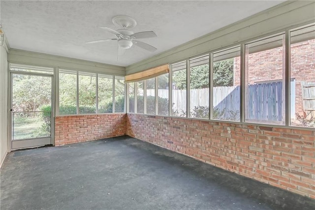 unfurnished sunroom with ceiling fan