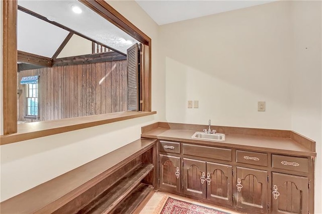 bathroom with vanity and lofted ceiling