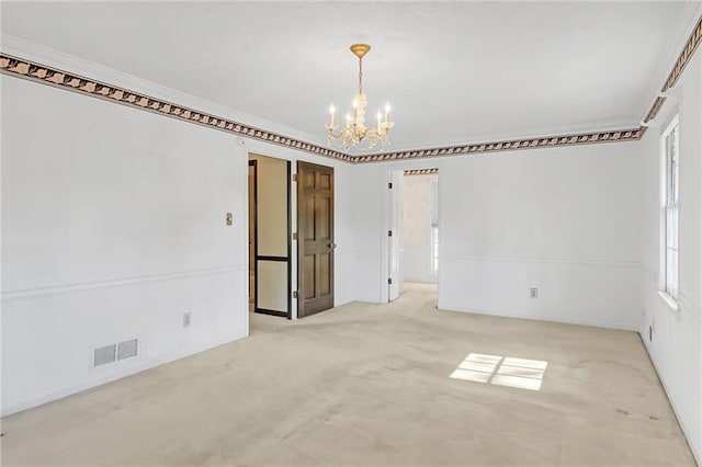 carpeted empty room with visible vents, crown molding, and an inviting chandelier