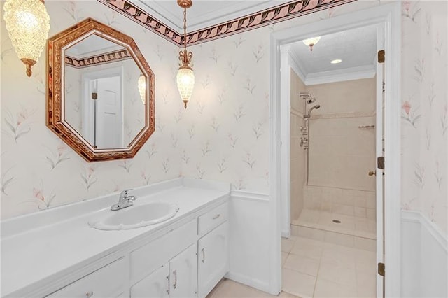 bathroom with crown molding, wallpapered walls, tiled shower, and vanity