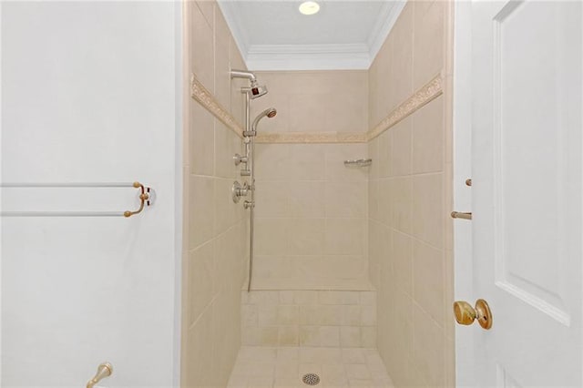 full bathroom with a tile shower and ornamental molding