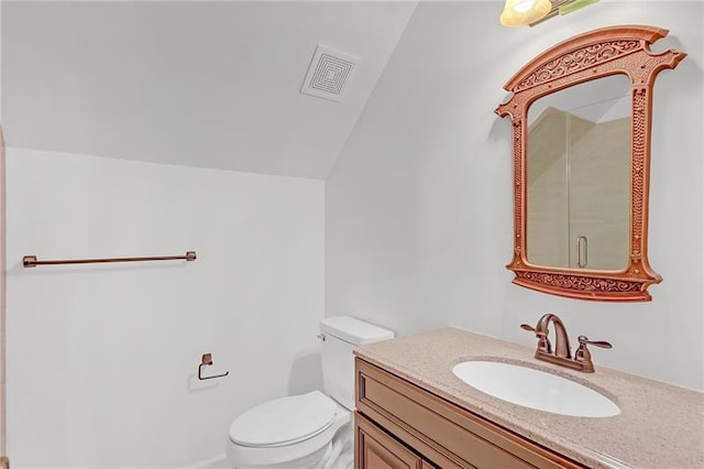 bathroom with toilet, visible vents, vaulted ceiling, and vanity