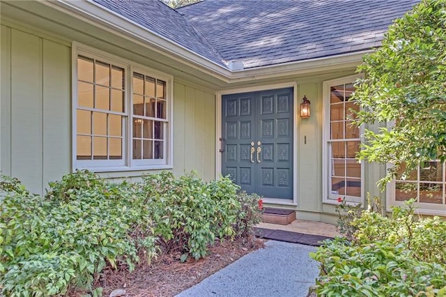 property entrance featuring roof with shingles