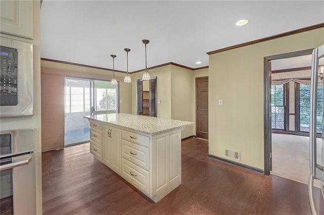 kitchen with dark wood-style flooring, decorative light fixtures, crown molding, visible vents, and recessed lighting