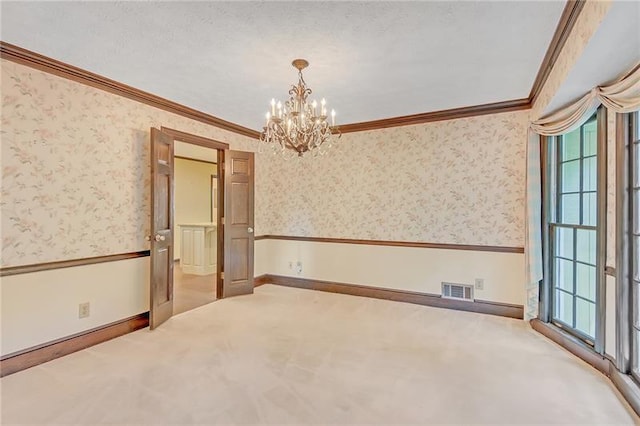unfurnished room featuring carpet floors, ornamental molding, a chandelier, and wallpapered walls