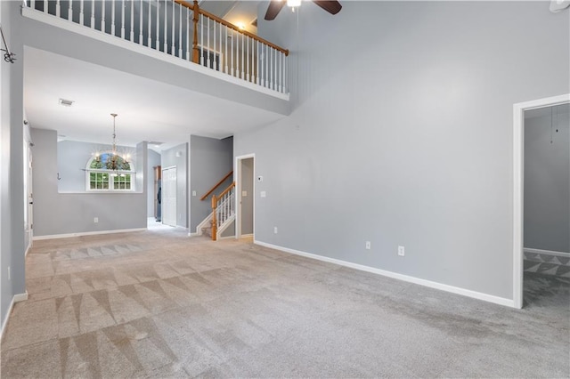412 Mcafee Ct NW Unit 14, Kennesaw, GA 30144 - unfurnished living room with ceiling fan, carpet floors, stairway, a towering ceiling, and baseboards