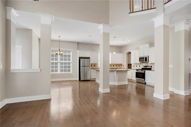 unfurnished living room with recessed lighting, baseboards, and dark wood-style floors