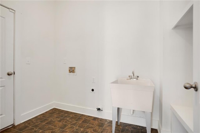 clothes washing area with hookup for an electric dryer, hookup for a washing machine, laundry area, and baseboards