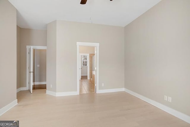 unfurnished bedroom featuring baseboards, a ceiling fan, and light wood finished floors