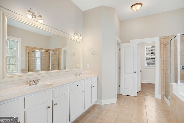 full bathroom with tile patterned floors, a stall shower, and a sink