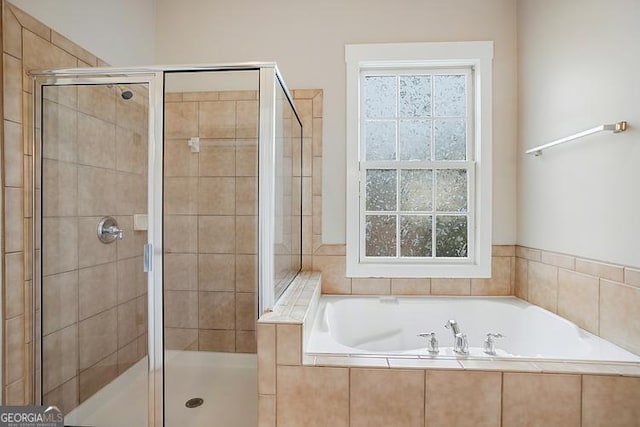 bathroom with a garden tub and a stall shower