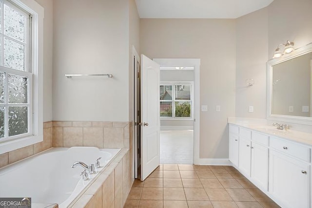 full bath featuring tile patterned floors, a garden tub, and vanity