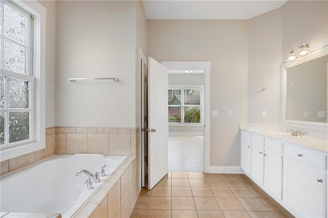 bathroom featuring baseboards, a garden tub, tile patterned flooring, and vanity