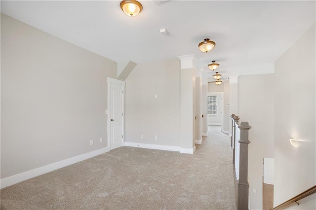 carpeted empty room with baseboards