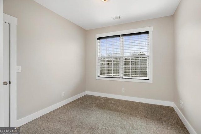 unfurnished room featuring visible vents, baseboards, and carpet floors