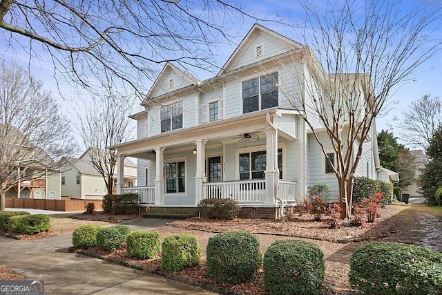 view of front of home with a porch and fence