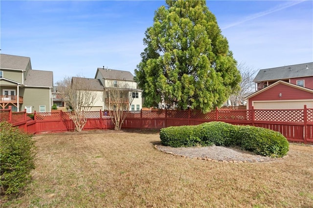view of yard with a fenced backyard and a residential view