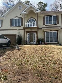 view of front of home featuring a garage and stucco siding