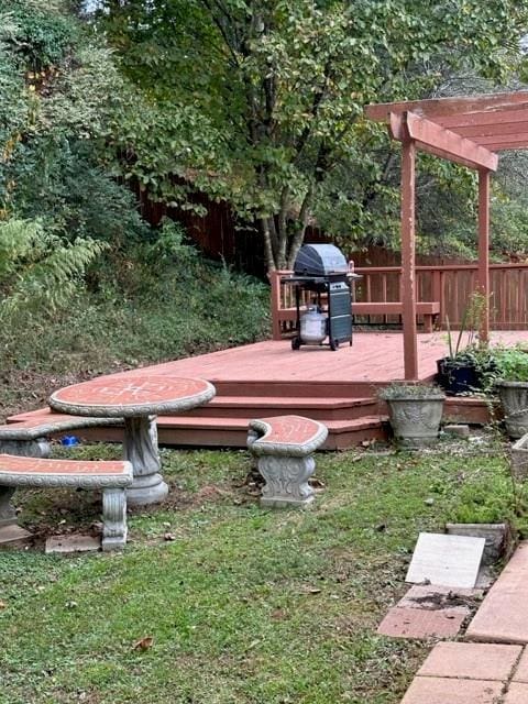 view of yard featuring a deck and fence