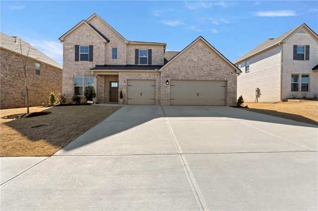 traditional home featuring concrete driveway, brick siding, and an attached garage