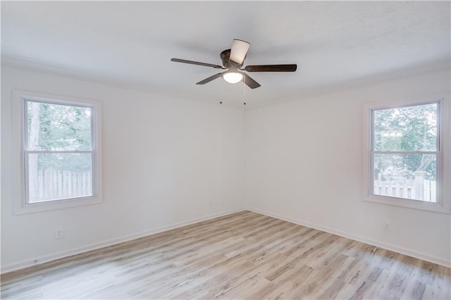 unfurnished room featuring light wood-style flooring, baseboards, a ceiling fan, and ornamental molding