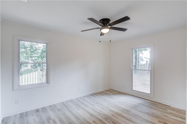 unfurnished room featuring ornamental molding, ceiling fan, baseboards, and wood finished floors