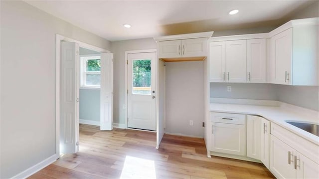 86 Martin Luther King Jr Dr, Jefferson, GA 30549 - kitchen with white cabinetry, light countertops, light wood-type flooring, recessed lighting, and baseboards