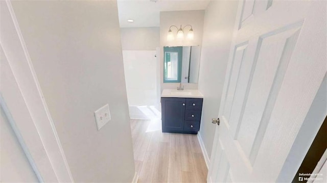 86 Martin Luther King Jr Dr, Jefferson, GA 30549 - full bathroom with vanity, wood finished floors, and baseboards