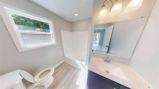 86 Martin Luther King Jr Dr, Jefferson, GA 30549 - bathroom featuring toilet, vanity, wood finished floors, and baseboards