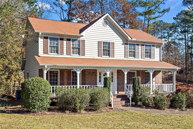 view of front of house featuring a porch and a front lawn