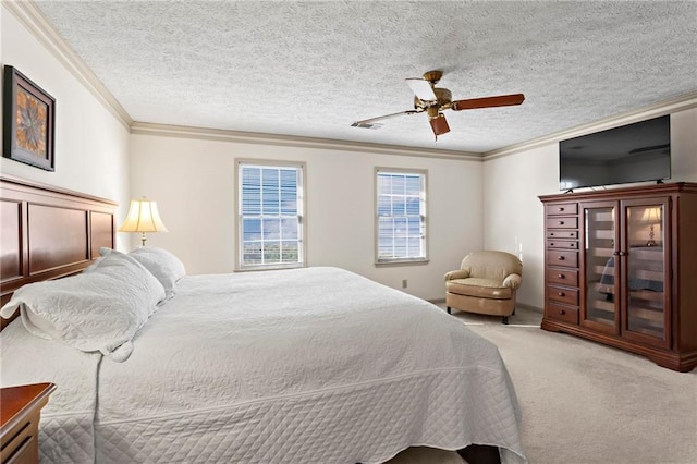 carpeted bedroom with ceiling fan, ornamental molding, and a textured ceiling