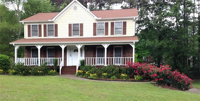 view of front of property with a porch and a front yard