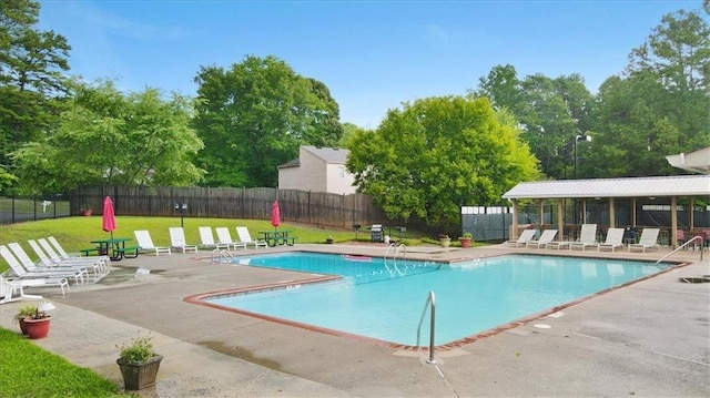 view of swimming pool featuring a yard and a patio