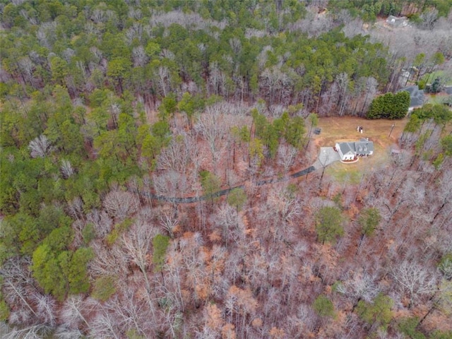 birds eye view of property featuring a wooded view