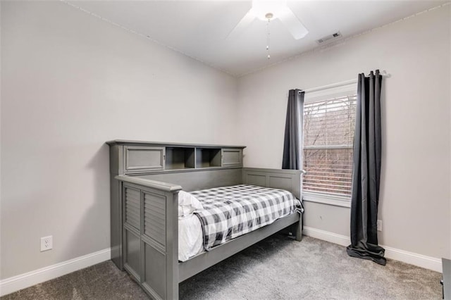 carpeted bedroom featuring baseboards, visible vents, and a ceiling fan