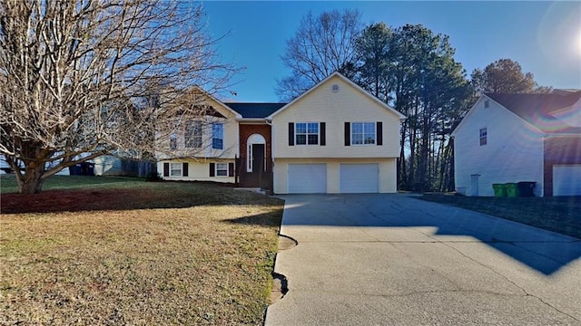 bi-level home with a garage and a front yard